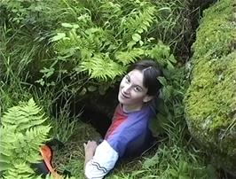Tao climbs out of the cave's rear entrance